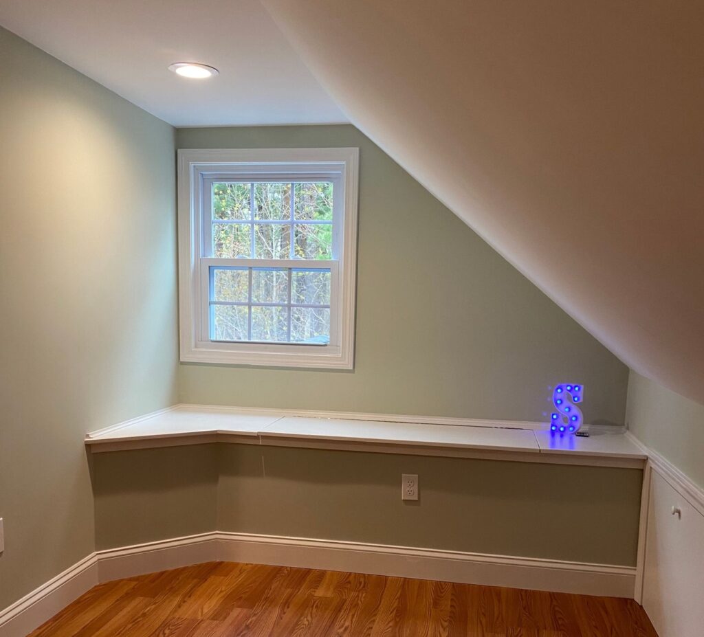 Built-in window bench in the finished Canton, MA attic by Appena Properties