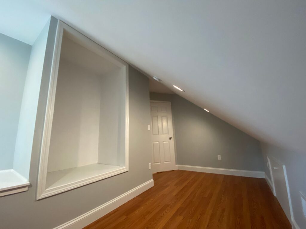 Finished attic with sloped ceiling and hardwood floor in Canton, MA
