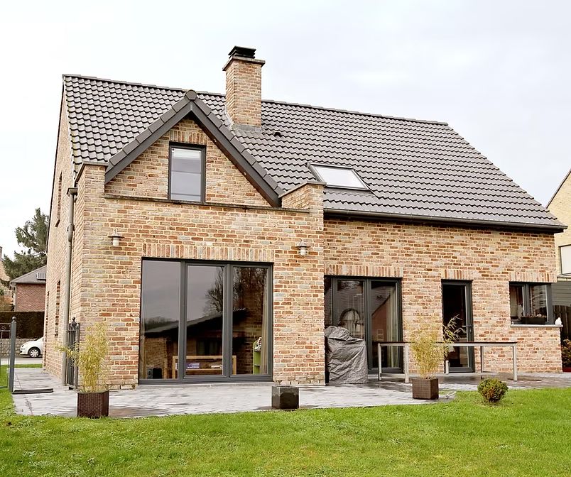 Brick house with large windows – home remodeling and additions