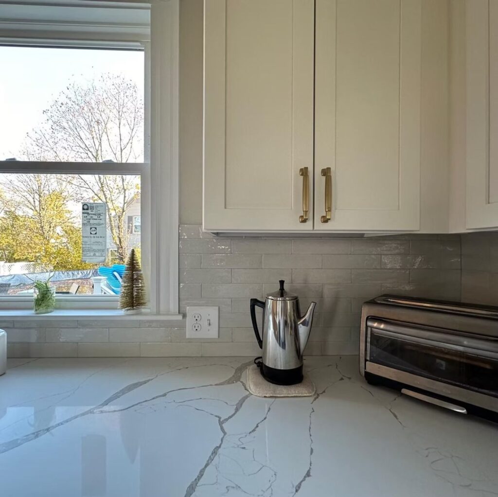 White kitchen cabinets and marble-look quartz countertop in Walpole, MA