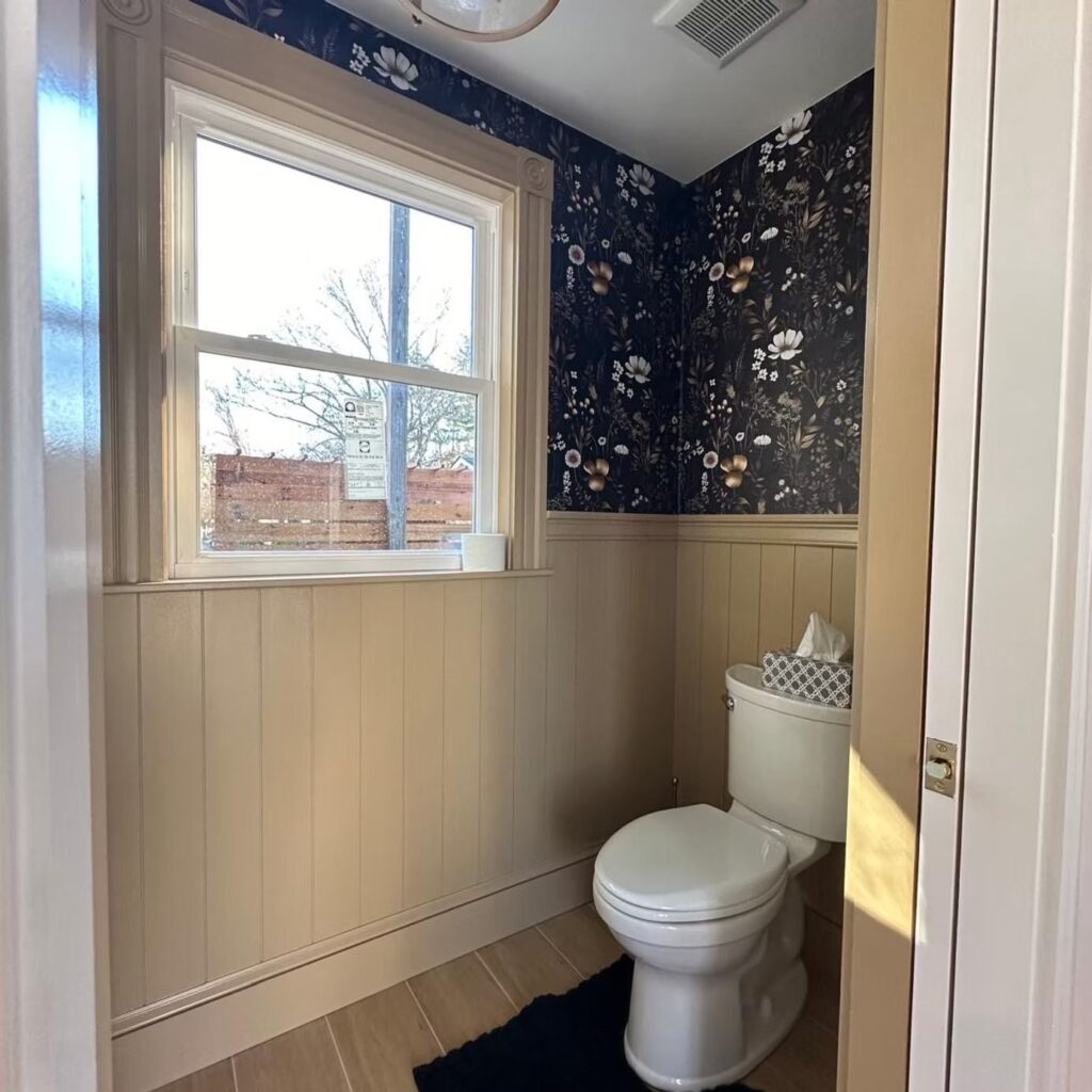 Half bathroom with wallpaper and window in Walpole, MA